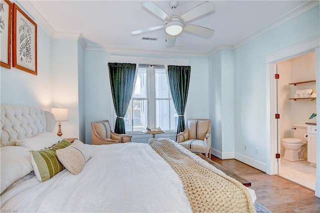 bedroom with crown molding, ensuite bath, ceiling fan, and light wood-type flooring