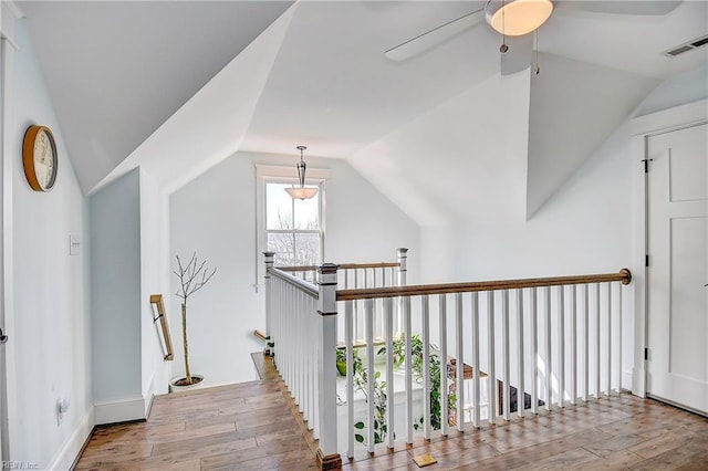 hall with hardwood / wood-style flooring and lofted ceiling