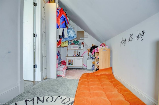 carpeted bedroom featuring lofted ceiling