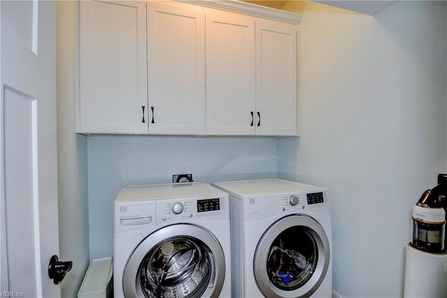 washroom with cabinets and washer and dryer