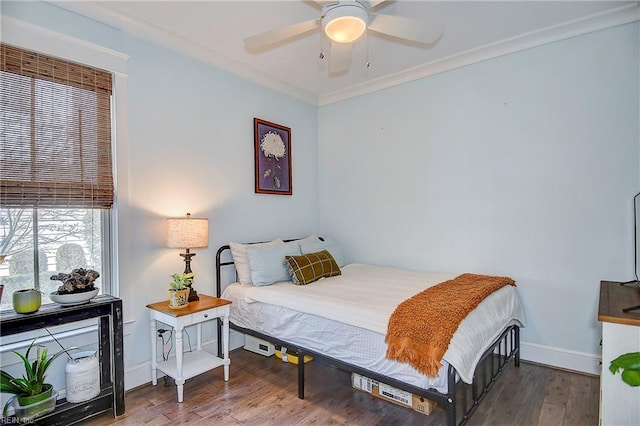 bedroom with hardwood / wood-style floors, crown molding, and ceiling fan