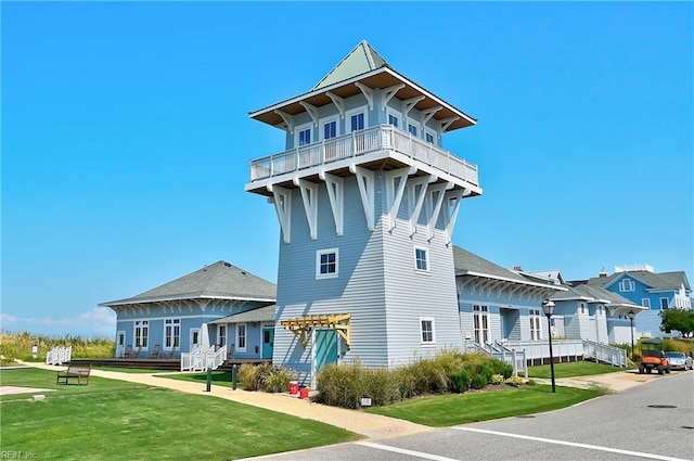 view of front of house with a pergola and a front lawn