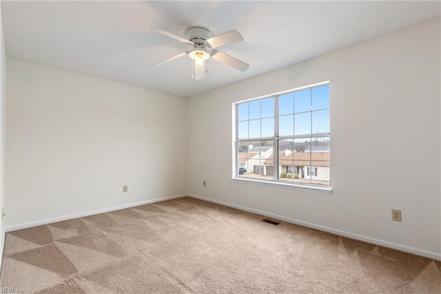 carpeted empty room featuring ceiling fan