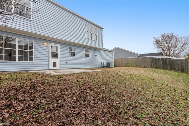 back of property with a yard, central AC, and a patio area