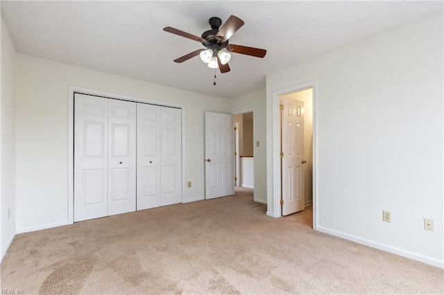 unfurnished bedroom with light colored carpet, a closet, and ceiling fan