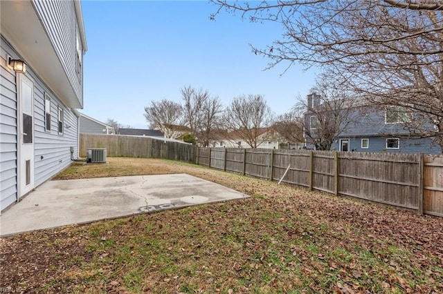 view of yard featuring central AC unit and a patio