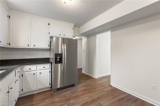 kitchen with stainless steel refrigerator with ice dispenser, dark hardwood / wood-style flooring, a textured ceiling, and white cabinets