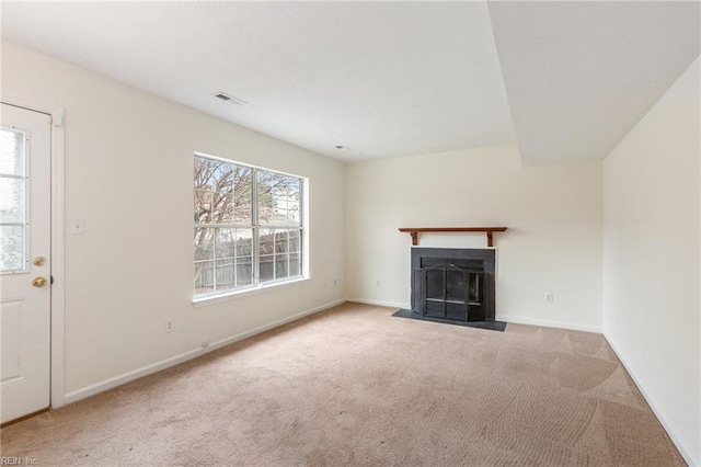 unfurnished living room featuring light colored carpet