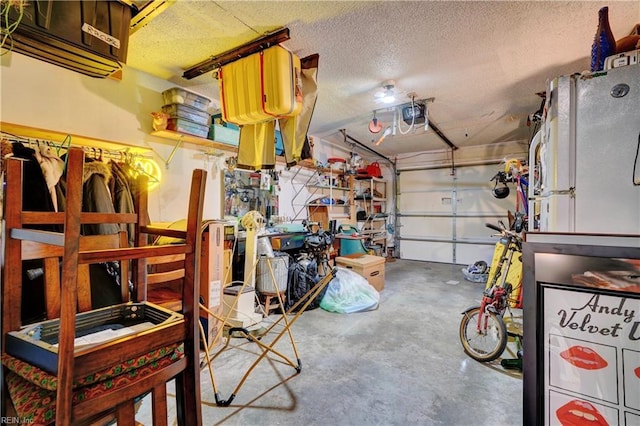 garage with white refrigerator and a garage door opener