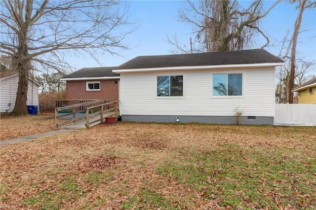 rear view of property featuring a lawn