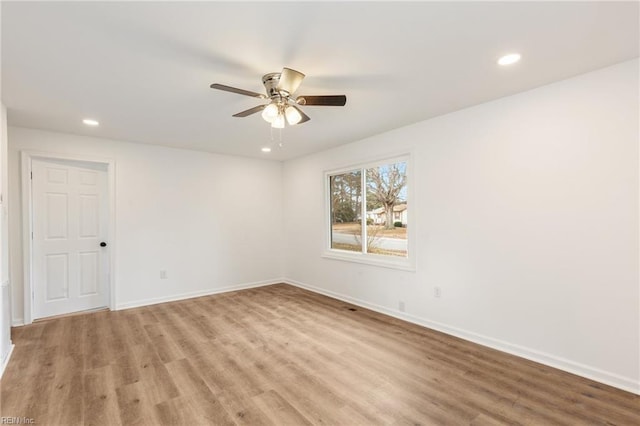 spare room featuring ceiling fan and light hardwood / wood-style floors