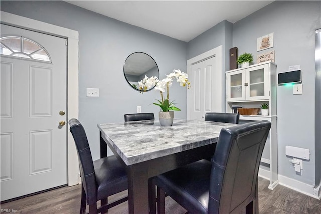 dining room with dark hardwood / wood-style flooring