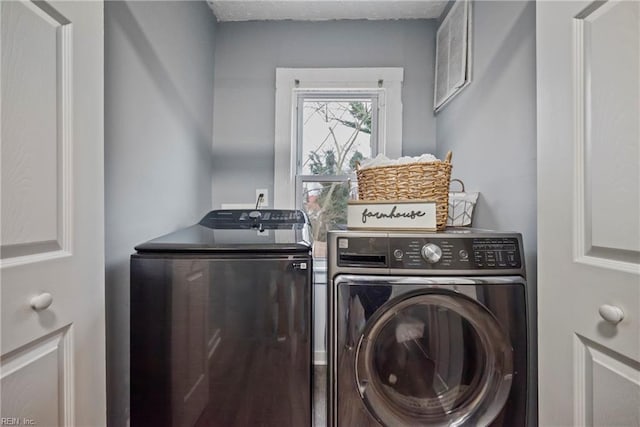 washroom featuring washer and dryer