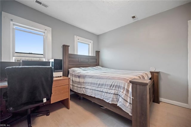 bedroom with light hardwood / wood-style floors