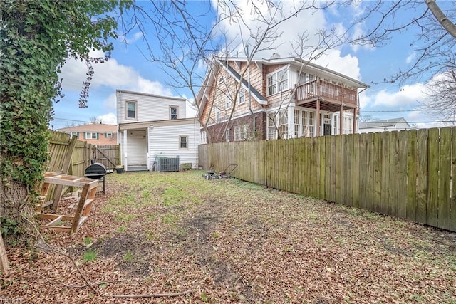 back of house featuring a balcony and central AC unit