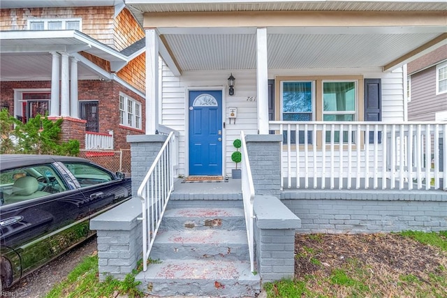 entrance to property featuring a porch