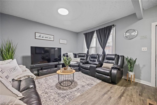 living room with hardwood / wood-style flooring and beamed ceiling