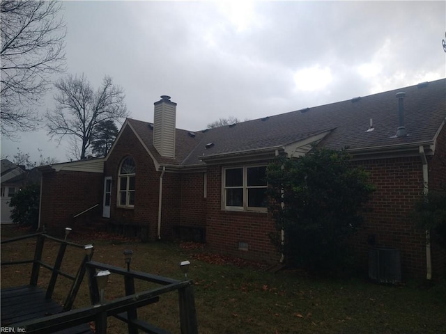 rear view of house featuring central air condition unit