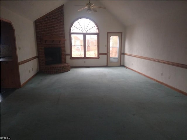 unfurnished living room with ceiling fan, high vaulted ceiling, carpet floors, and a fireplace