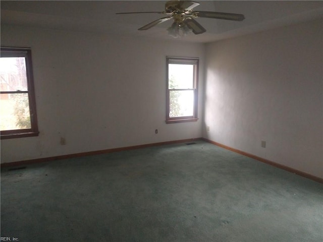 carpeted spare room with ceiling fan