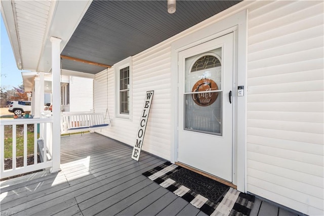 view of exterior entry with covered porch