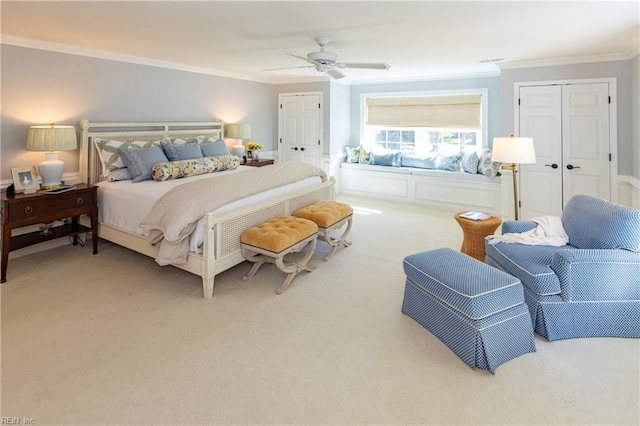 bedroom with carpet floors, ornamental molding, and ceiling fan