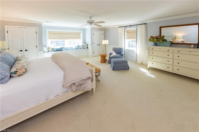 bedroom with light carpet, ornamental molding, and ceiling fan