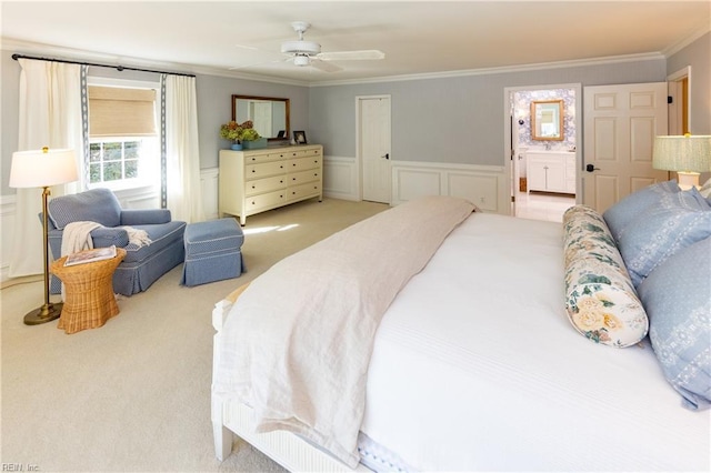 bedroom with light carpet, ensuite bath, ornamental molding, and ceiling fan