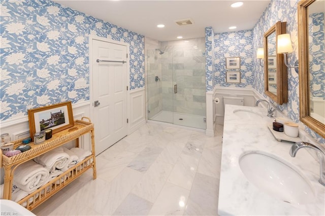 bathroom with a shower with door and vanity