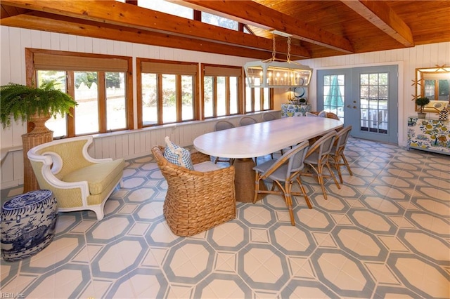 dining area featuring beamed ceiling, plenty of natural light, french doors, and wooden ceiling