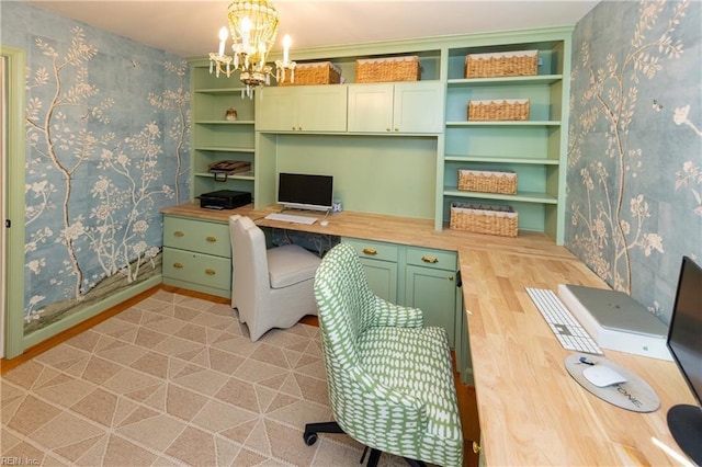 office space featuring built in desk and an inviting chandelier