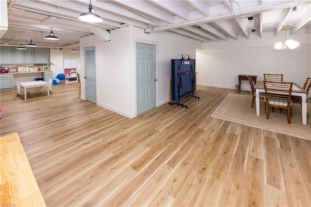 dining space with beamed ceiling and light hardwood / wood-style floors