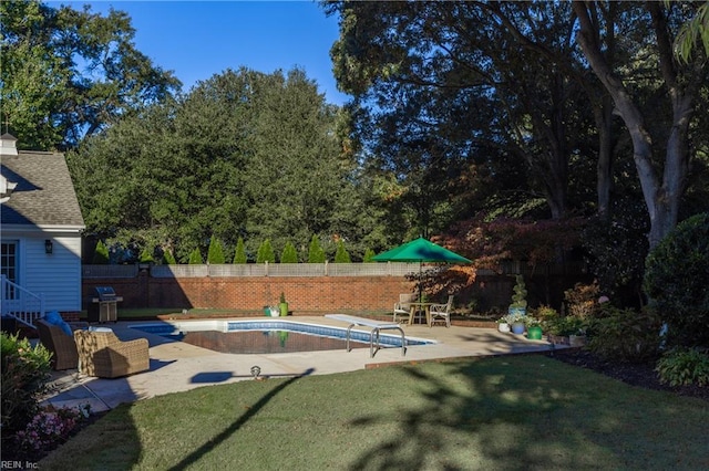 view of pool with grilling area, a lawn, a diving board, and a patio area