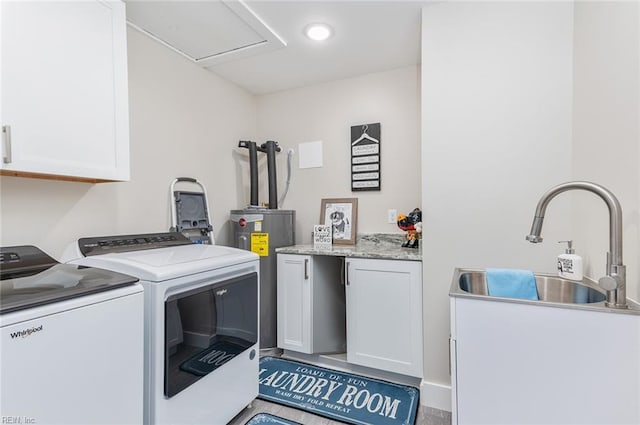 washroom featuring cabinets, sink, washer and clothes dryer, and electric water heater