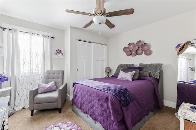 carpeted bedroom with a closet and ceiling fan