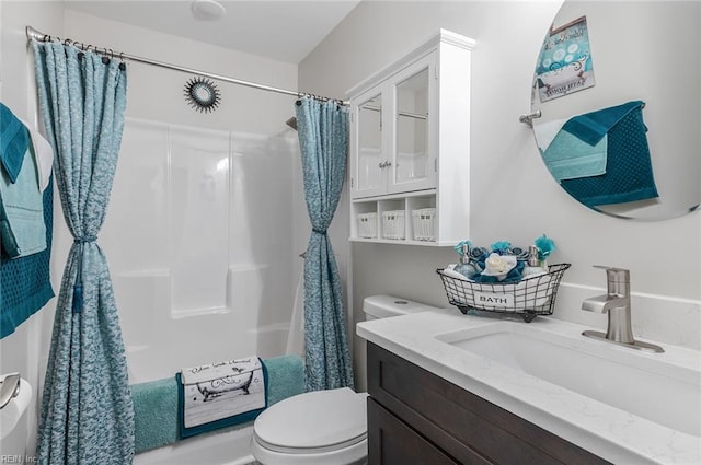 full bathroom with shower / tub combo, vanity, and toilet