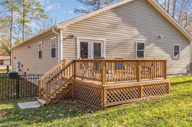 rear view of house with a yard and a deck