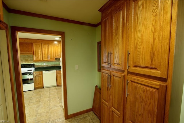 kitchen featuring crown molding, white appliances, and backsplash