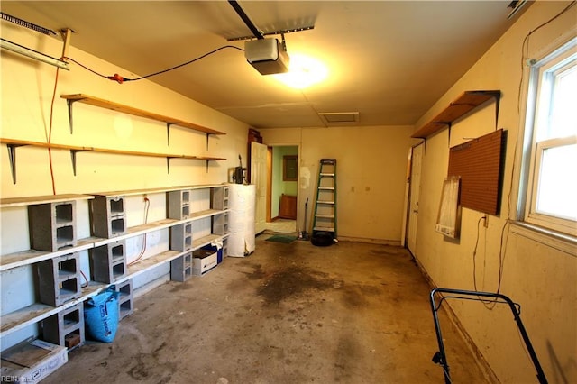 garage with a garage door opener and electric panel