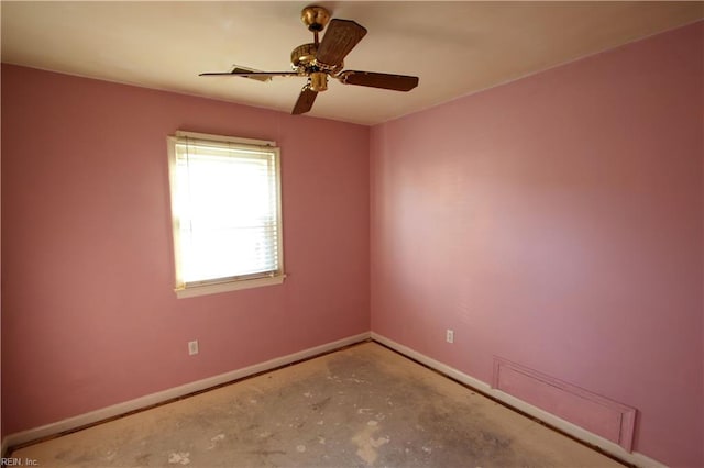 unfurnished room with ceiling fan and concrete floors