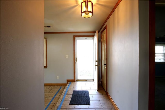 doorway featuring light tile patterned floors and ornamental molding