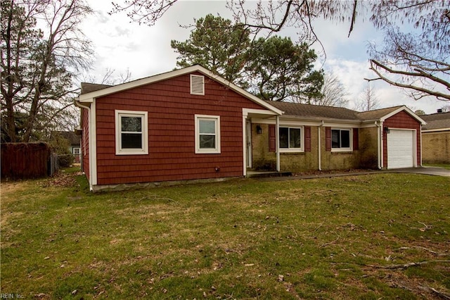 ranch-style home with a garage and a front lawn