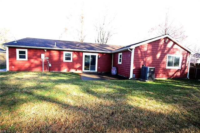 rear view of house with a yard and central AC unit