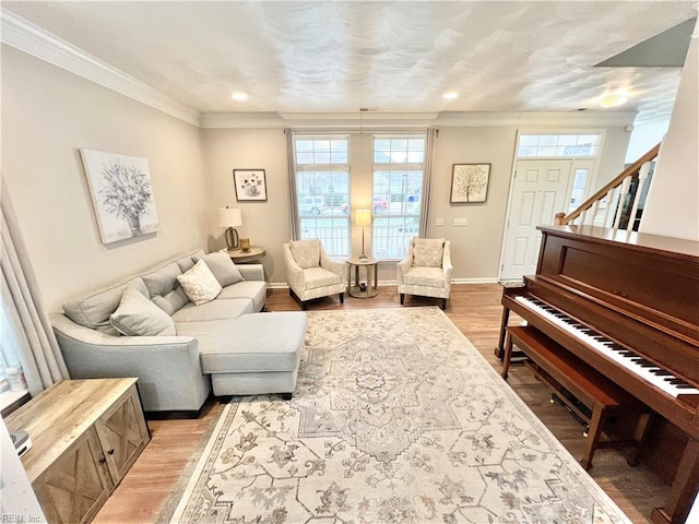 living room featuring ornamental molding and light hardwood / wood-style flooring