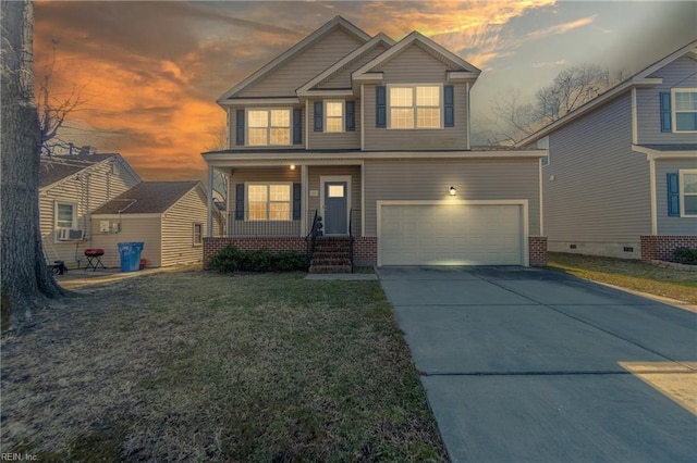 craftsman-style home featuring a porch, a garage, and a lawn