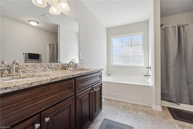 bathroom with vanity, tile patterned flooring, and a washtub