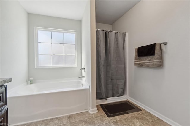 bathroom with tile patterned floors, vanity, and independent shower and bath