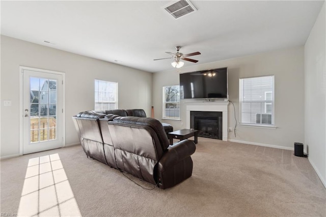 carpeted living room with ceiling fan