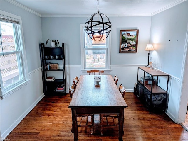 dining space with crown molding, dark hardwood / wood-style floors, and a notable chandelier