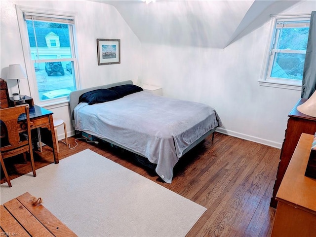 bedroom with dark hardwood / wood-style floors and vaulted ceiling